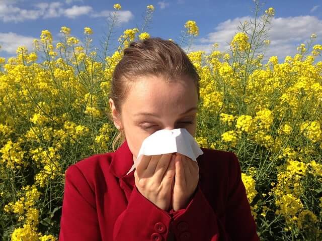 a woman blowing her nose