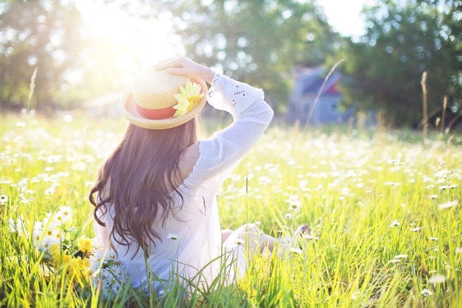 a woman sitting in a field