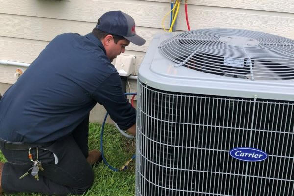 a technician working on an ac unit