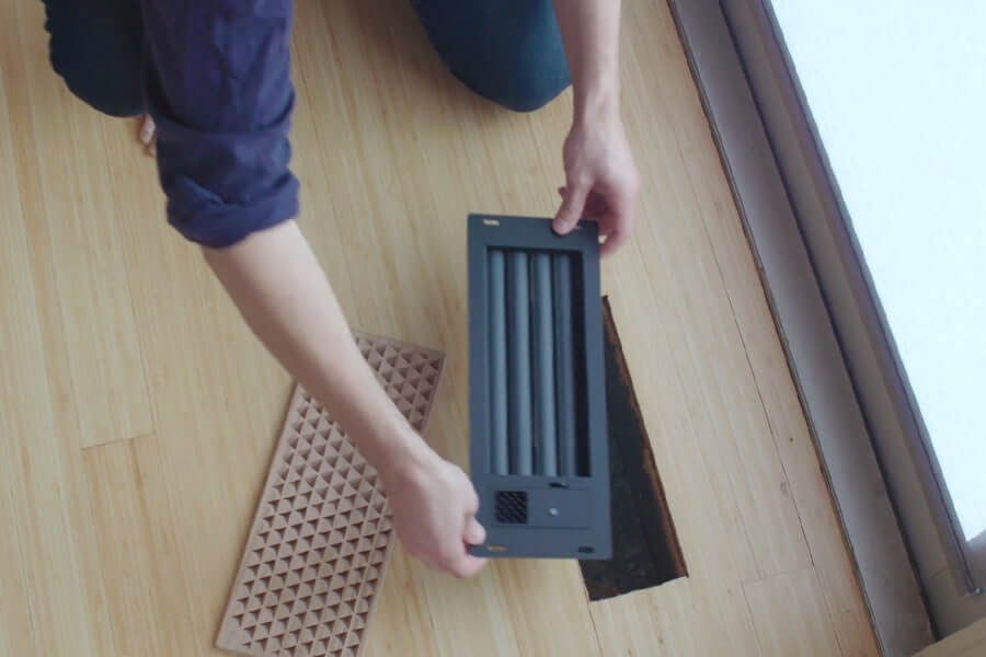 a person installing a smart vent