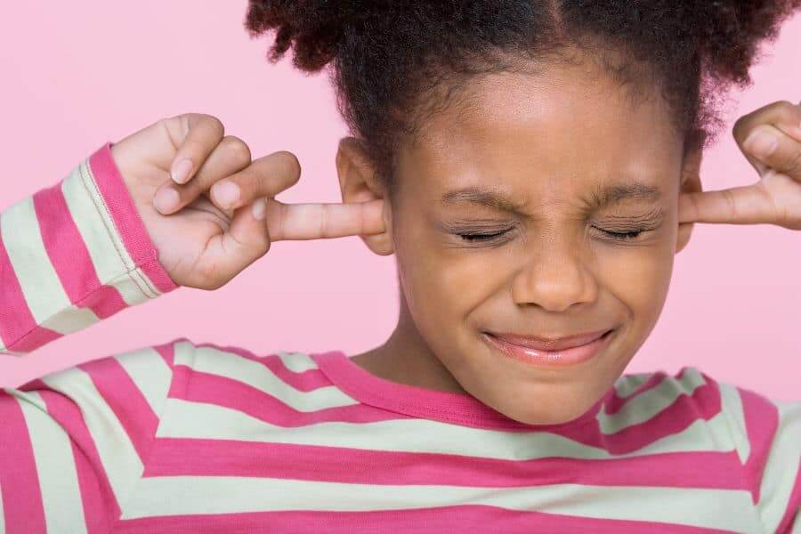 a child plugging their ears