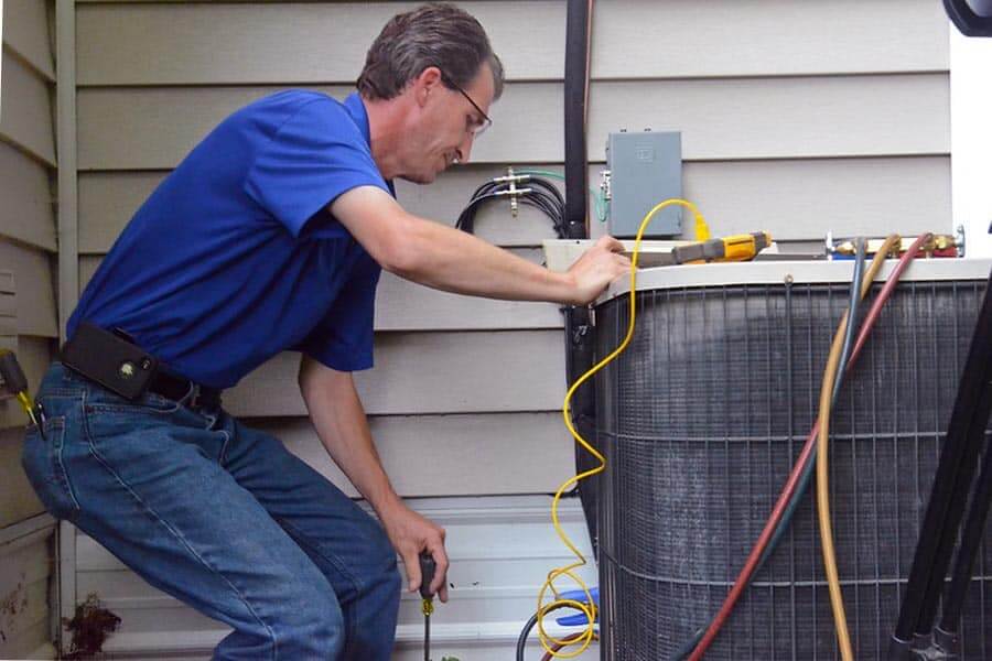 a technician working on a hvac unit San Marcos TX